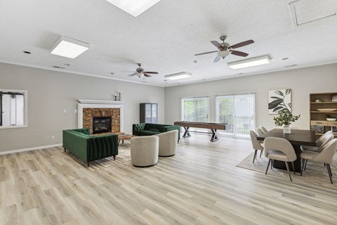 a living room with a fireplace and a table with chairs